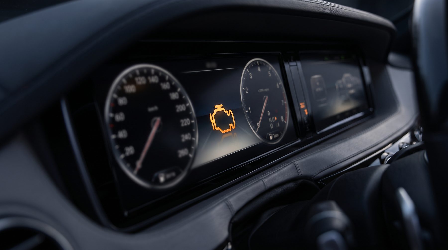 Amber engine management warning light glowing on a car instrument cluster