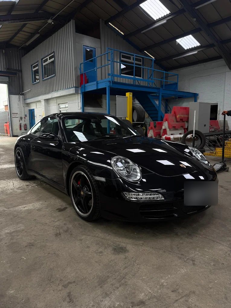 Black Porsche 911 Carrera S inside the new Liam's Tyres garage
